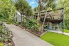 Contemporary Queenslander with Dual Living Amidst Lush Rainforest