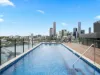Chic 2-bed apartment + a rooftop pool with epic city views!