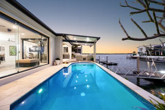 SCARCE SINGLE LEVEL WATERFRONT ELEGANCE ON SOVEREIGN ISLANDS WITH PROTECTED MOORING 