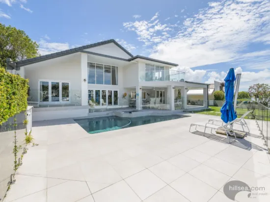 STUNNING WATERFRONT SANCTUARY COVE RESIDENCE WITH PRIVATE PONTOON & POOL